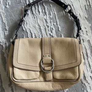 Coach pebbled genuine leather beige bag with buckle and pockets.